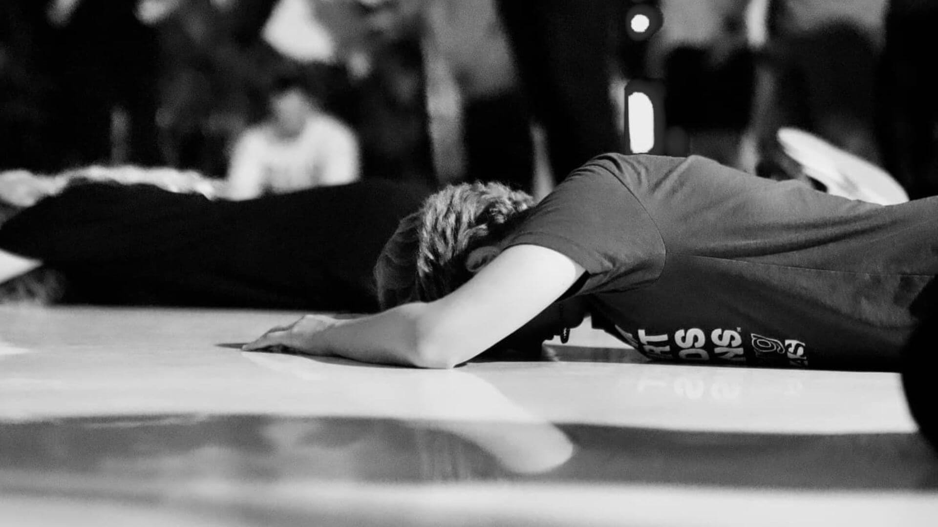 Woman laying face down at a Nations House of Prayer worship gathering in Houston