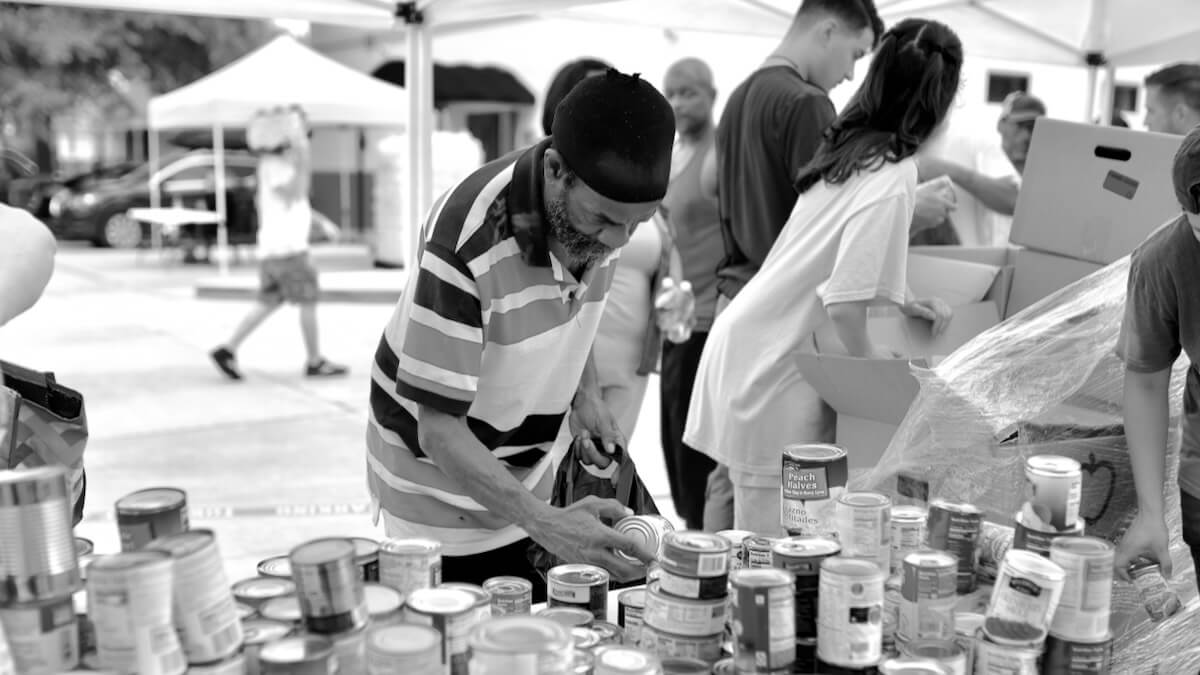A man receiving food at a food distribution at Nations House of Prayer